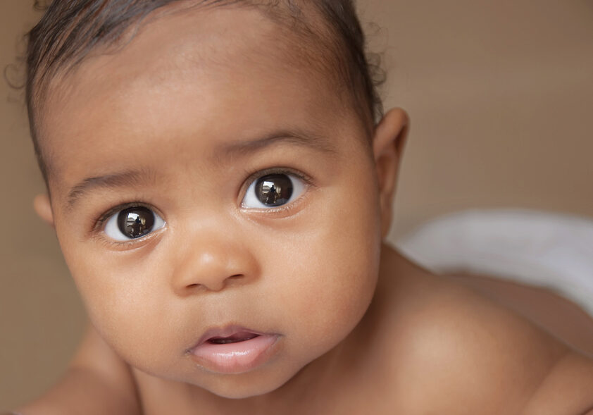 OH baby looking at camera Beautiful mixed race baby looking and the camera with a serene expression; Shutterstock ID 114548935; PO: Parentdish